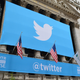 A banner above the New York Stock Exchange with the Twitter logo and the word @twitter below it.
